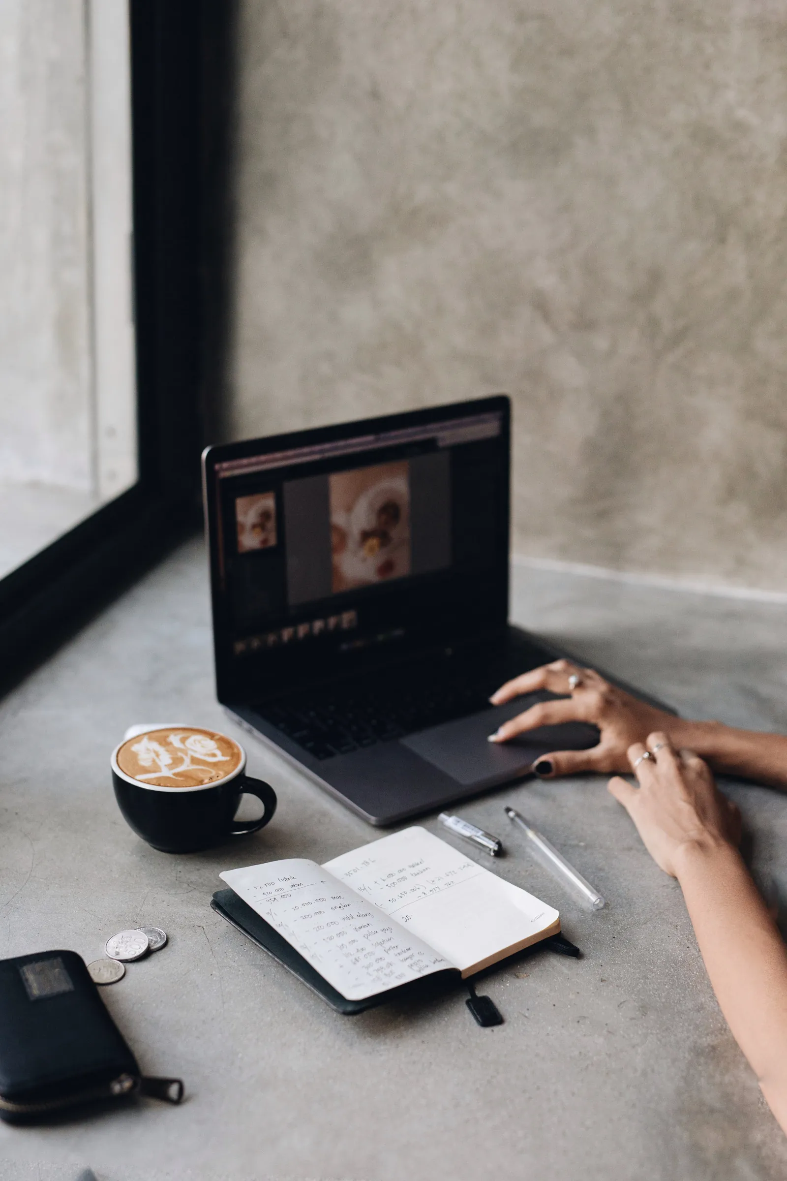Coffee, a notebook of figures and a laptop. Planning a small business